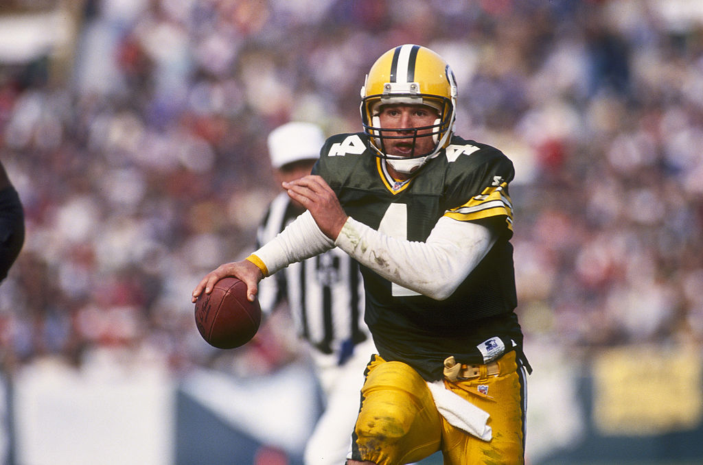 Packers quarterback, Brett Farve, eludes pressure from the defense.