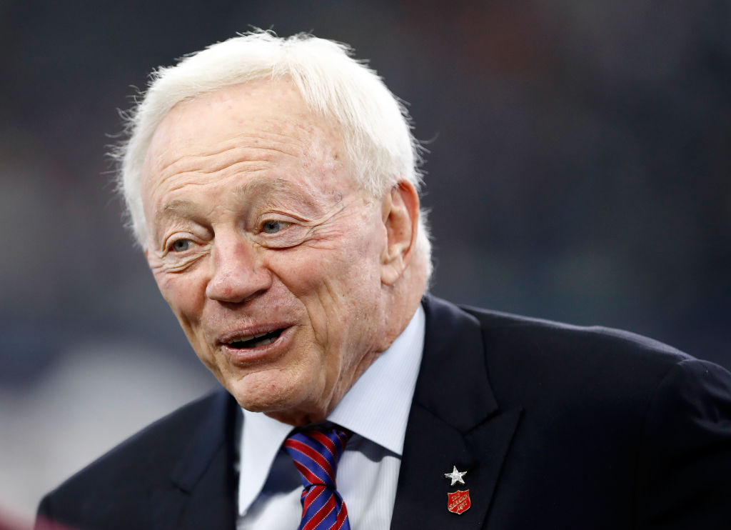 Jerry Jones stands on the field before an NFL game.