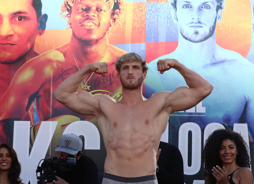 Logan Paul flexes before a boxing match weigh in