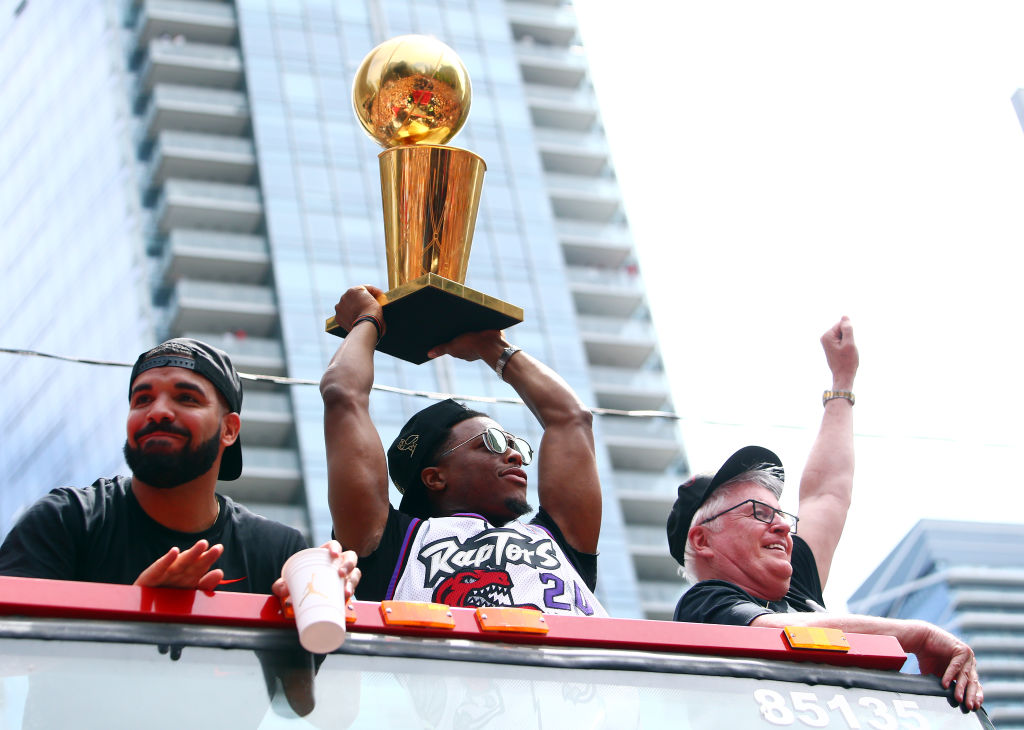 Kyle Lowry (center) and the Raptors enjoyed the prestige of winning the NBA title in 2019, and they got huge championship rings, but Drake (left) added another bit piece of loot to the haul.