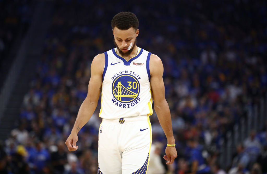 Golden State Warriors' guard Steph Curry hangs his head.