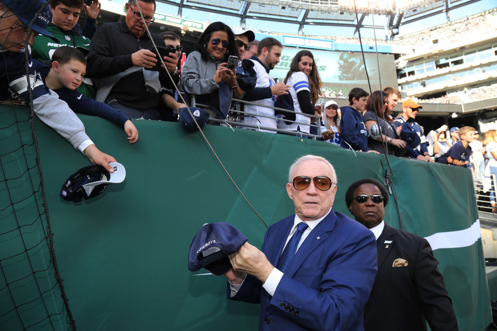 Team Owner Jerry Jones of the Dallas Cowboys signs autographs