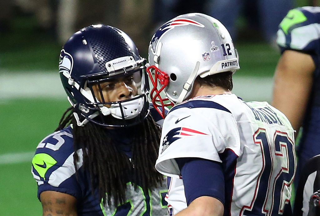 Tom Brady and Richard Sherman talking during a game.