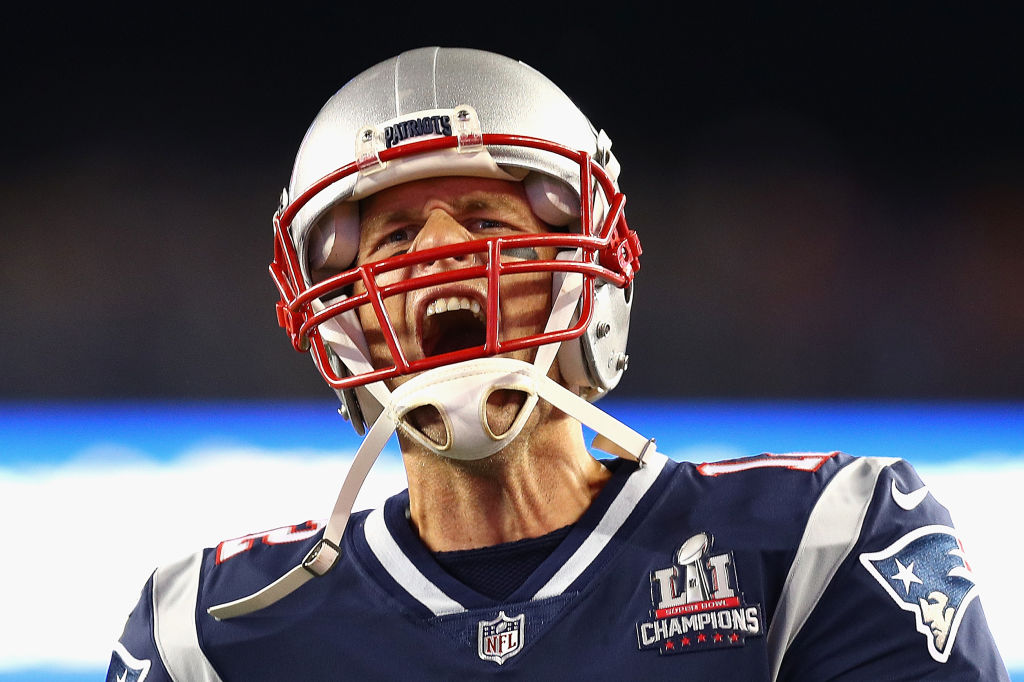 Tom Brady yells before taking the field for a football game.