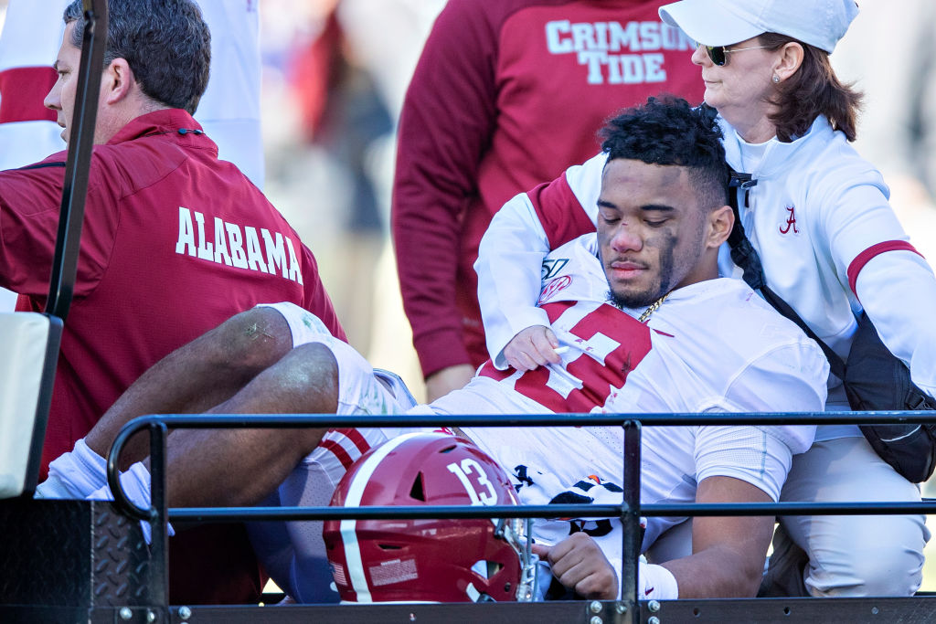 Tua Tagovailoa being carted off of the field in what will likely be his final appearance as a member of the Crimson Tide