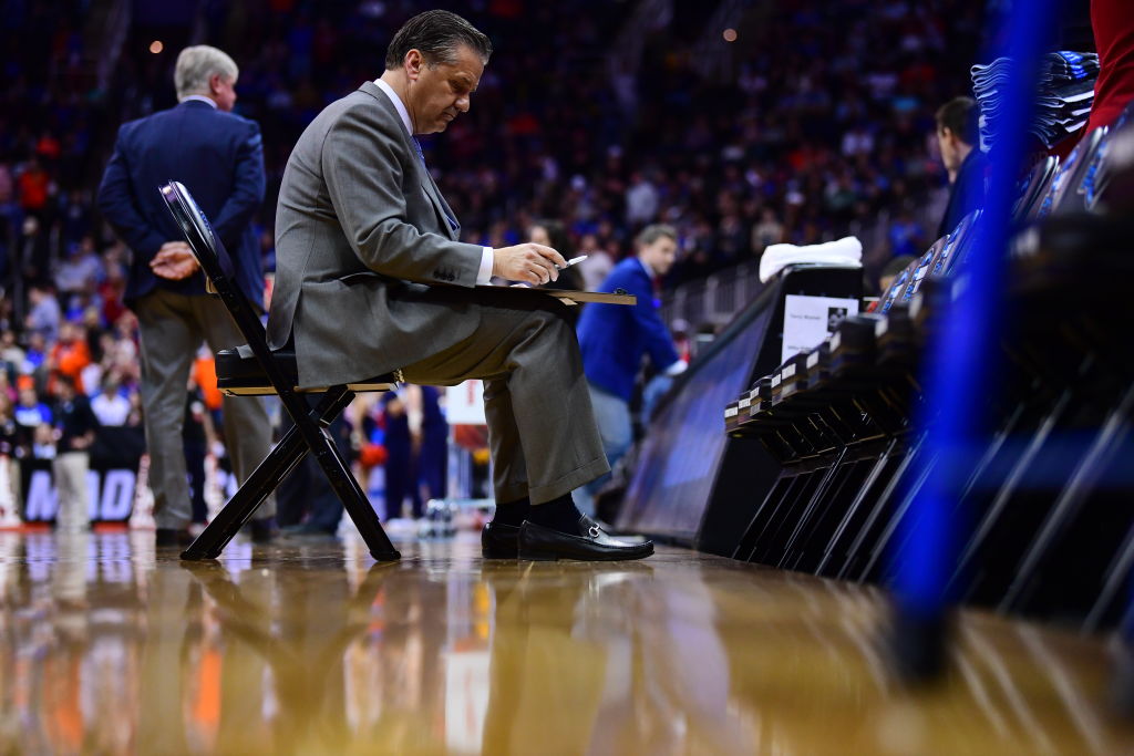 Head Coach John Calipari of the The Kentucky Wildcats writes down plays