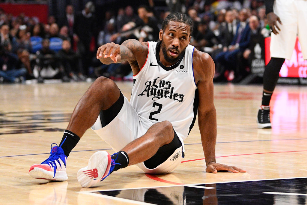 Kawhi Leonard getting up after falling down on the court.