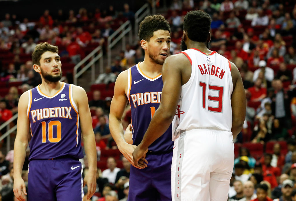 James Harden of the Houston Rockets and Devin Booker of the Phoenix Suns exchange words