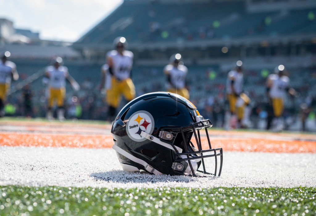 A helmet sits in the end zone as the Pittsburgh Steelers warm up