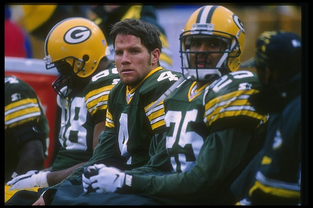 Quarterback Brett Favre of the Green Bay Packers looks on with teammates during a 1996 game