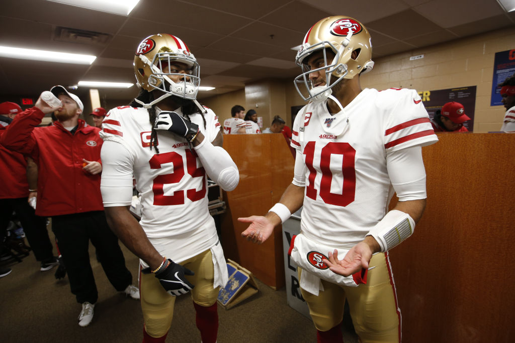 Richard Sherman and Jimmy Garoppolo of the San Francisco 49ers talk in the locker room prior to a game