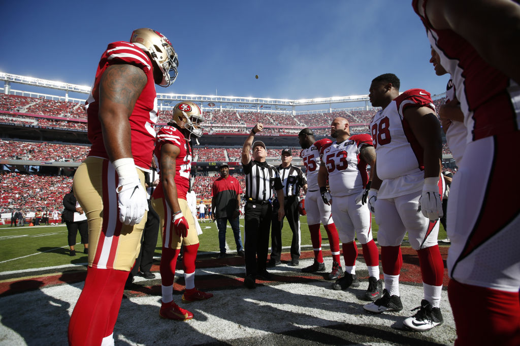 Captains of the San Francisco 49ers and the Arizona Cardinals meet at midfield for the coin toss