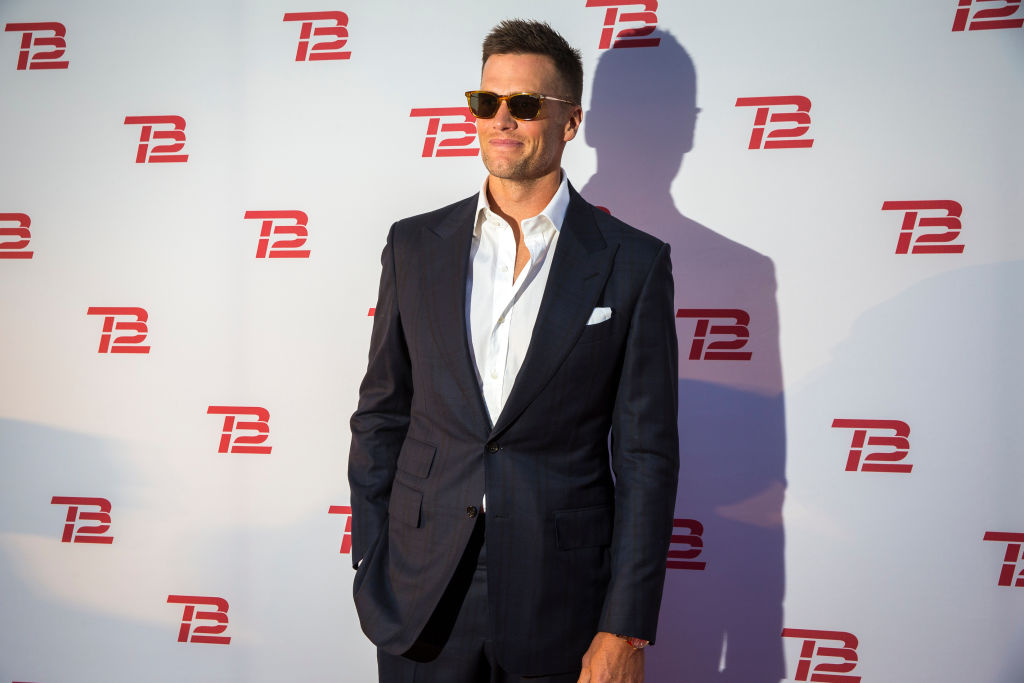 Tom Brady poses at a red carpet event for his new diet and lifestyle brand