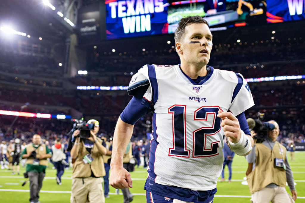 Tom Brady jogs off the field after a game.
