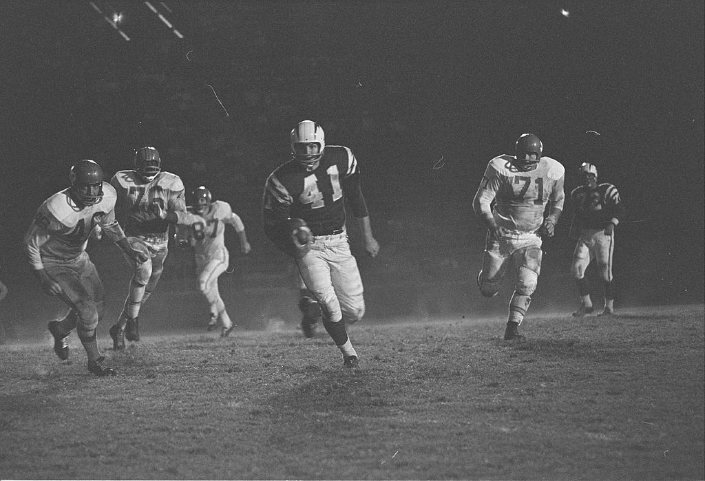 Los Angeles Chargers Fullback Charlie Flowers runs the ball as Dallas Texans defenders try to catch up
