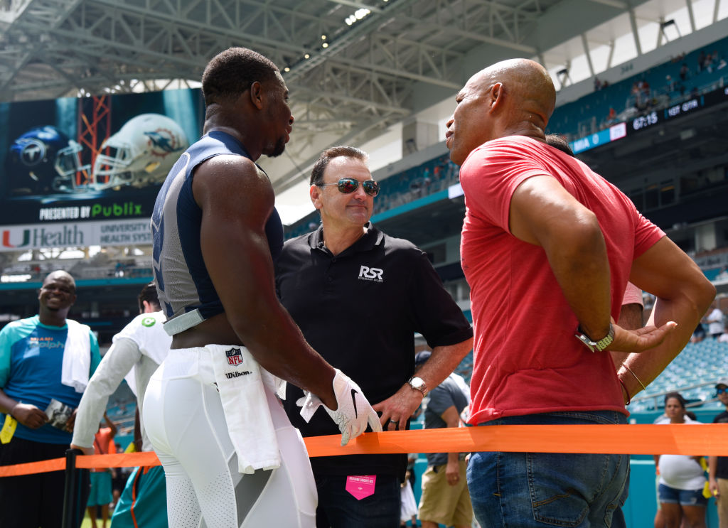 NFL agent Drew Rosenhaus speaks to players before a game