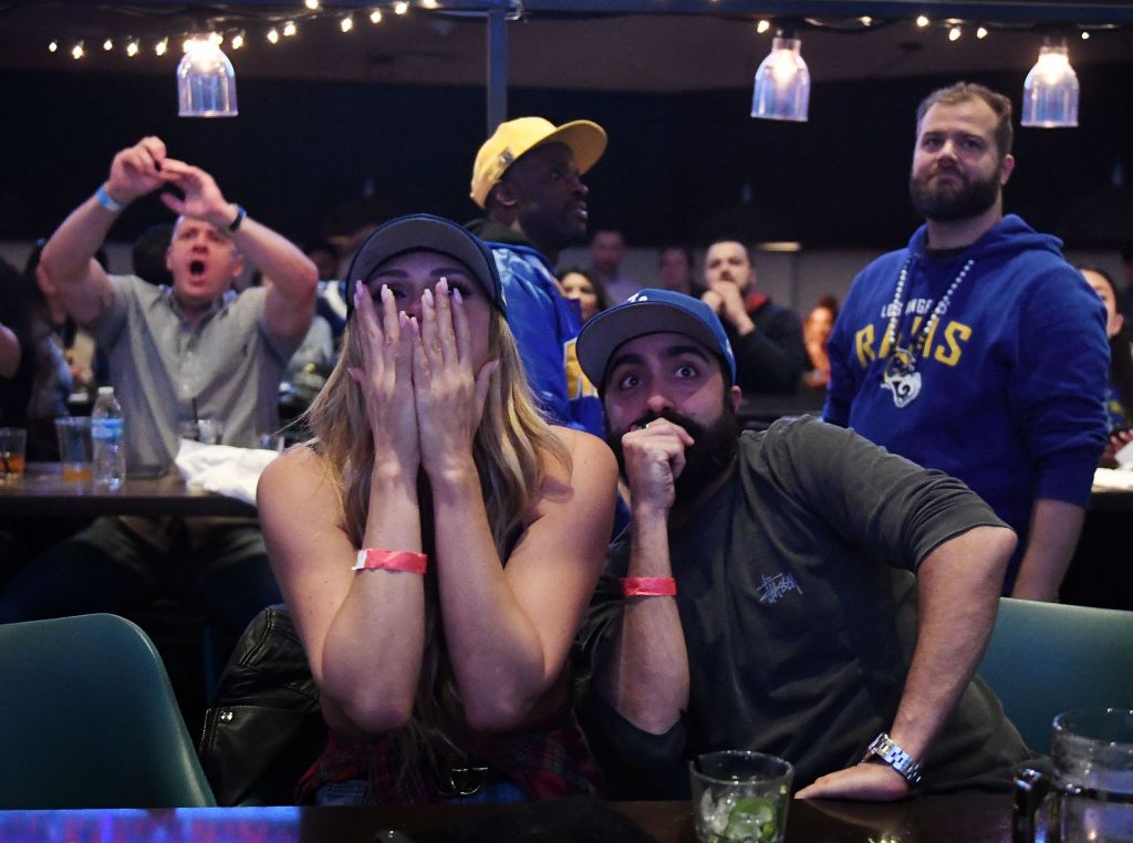 Los Angeles Rams fans Ella Silver (L) and Moe Helmy react to Super Bowl LIII