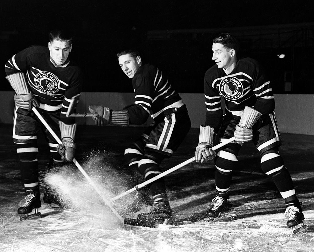 (L-R) Brothers Reg Bentley, Max Bentley and Doug Bentley of the Chicago Blackhawks pose on the ice on December 5, 1942