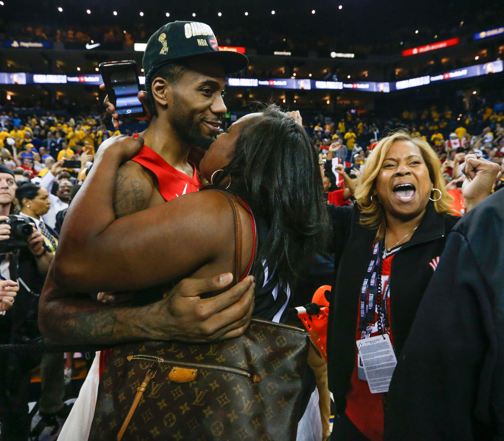 Toronto Raptors forward Kawhi Leonard celebrates with his family after a win