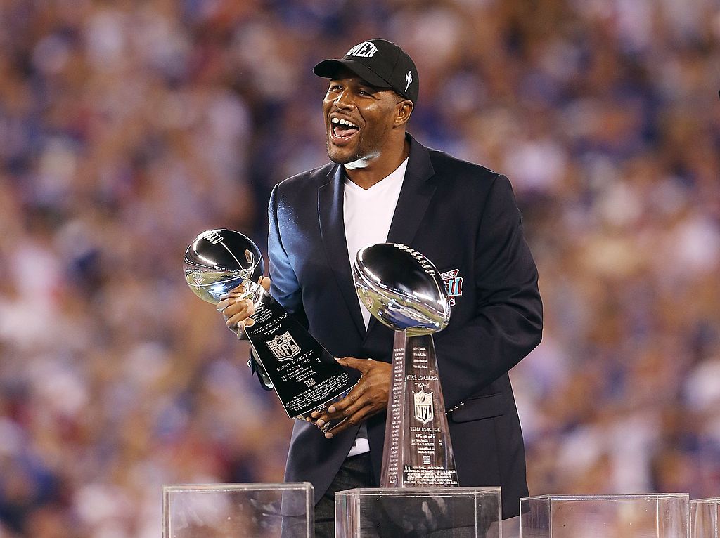 Former New York Giant Michael Strahan holds the Vince Lombardi trophy in 2012