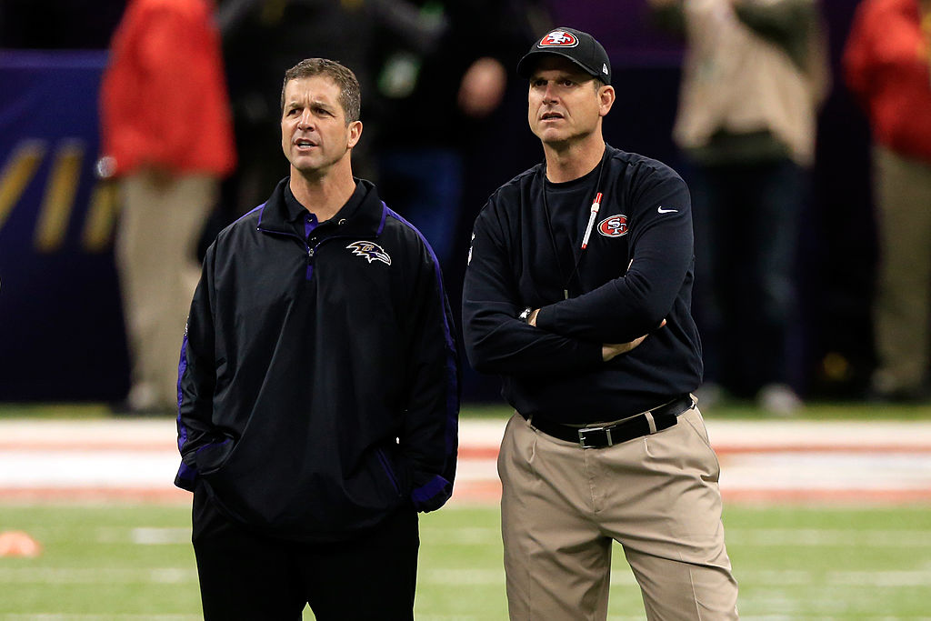 John and Jim Harbaugh standing at midfield before a game