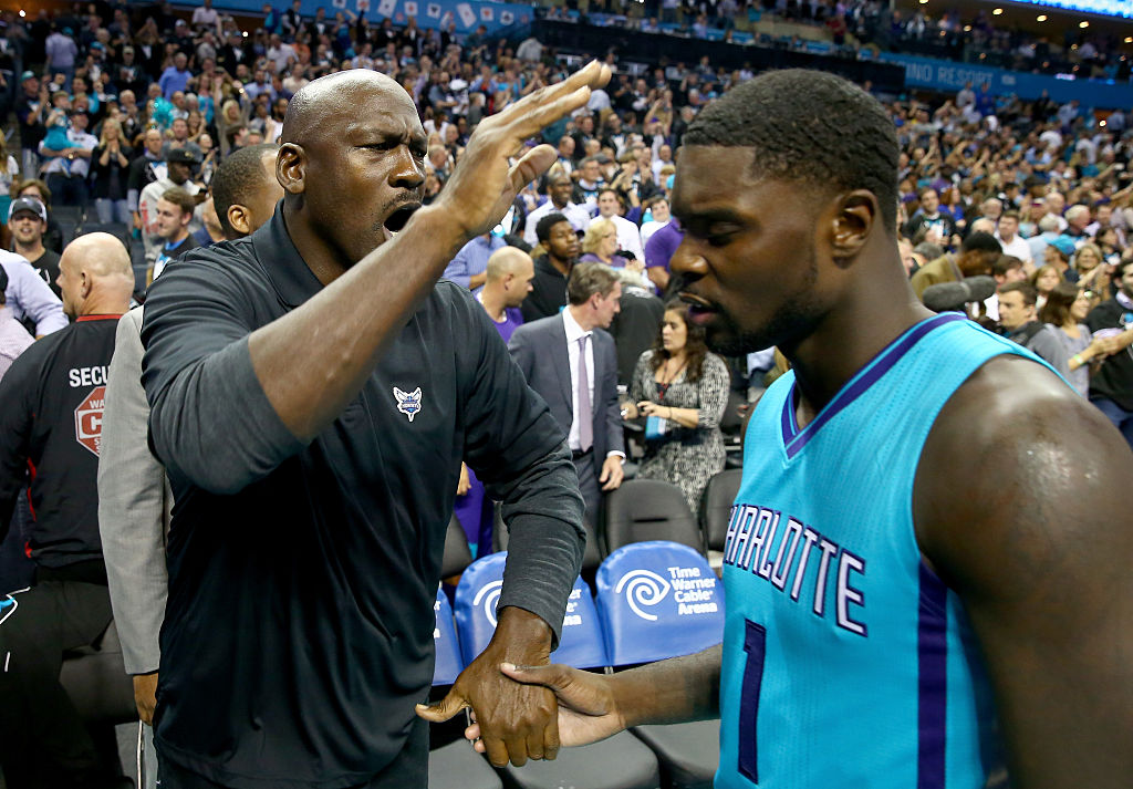 Charlotte Hornets owner Michael Jordan celebrating with a player