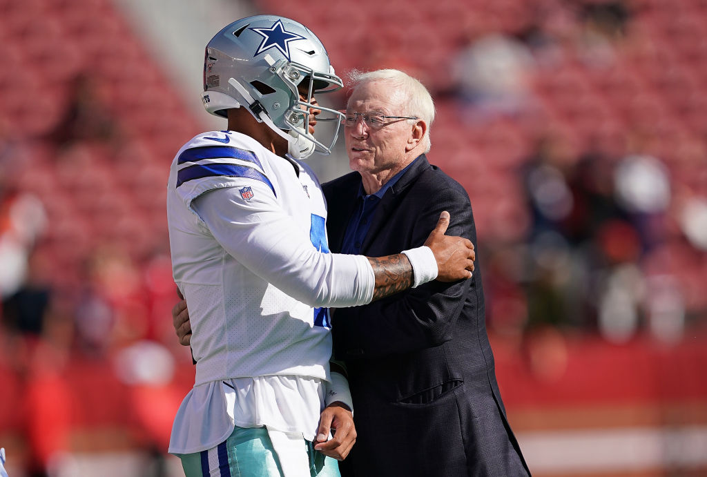 Quarterback Dak Prescott and team owner Jerry Jones of the Dallas Cowboys hug each other