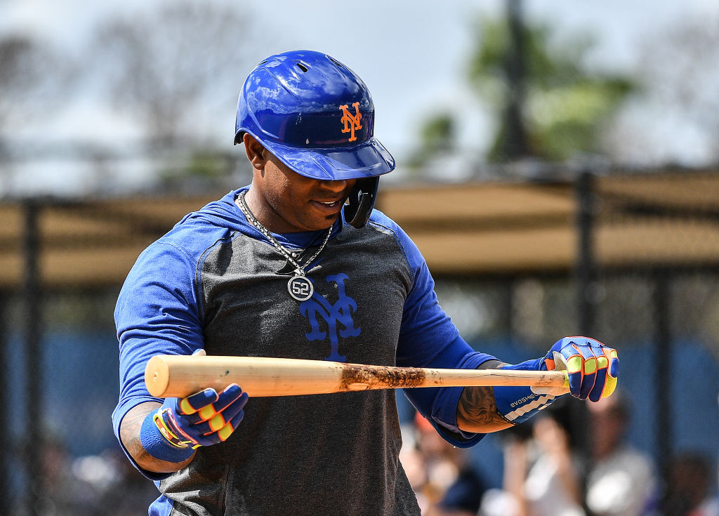 Yoenis Cespedes of the New York Mets checks his bat during a team workout
