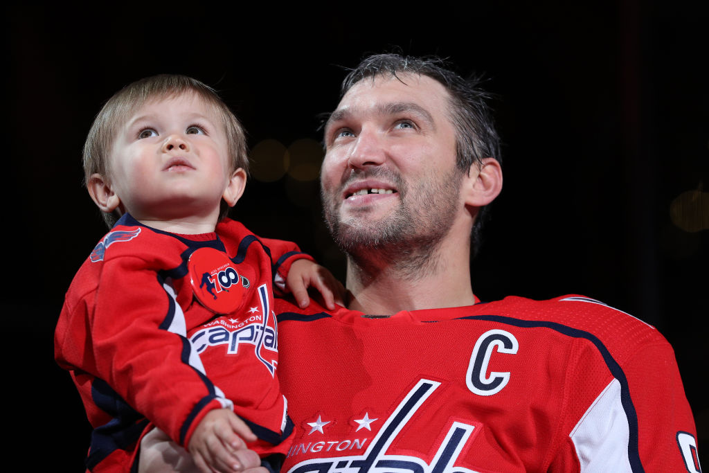 Alex Ovechkin of the Washington Capitals holds his son, Sergei, as he acknowledges the crowd