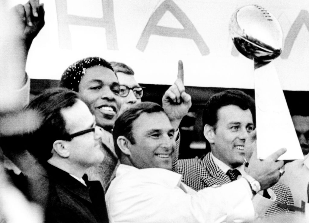 Head coach Hank Stram of the Kansas City Chiefs holds the Super Bowl Trophy as owner Lamar Hunt (L), Otis Taylor, and Len Dawson (R) win Super Bowl IV in 1970