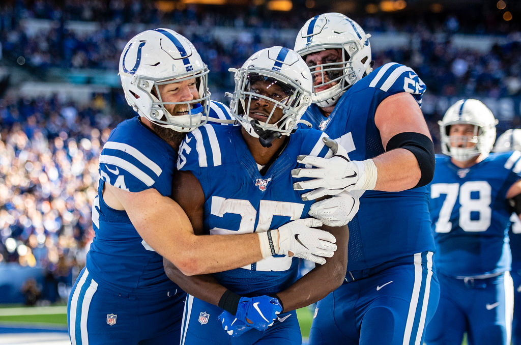 Jack Doyle, Marlon Mack, and Quenton Nelson, who play for the Indianapolis Colts, celebrate.
