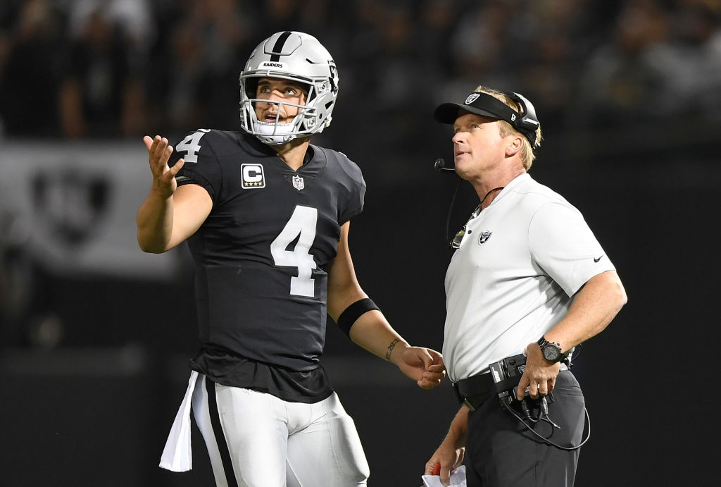 Derek Carr and Jon Gruden talking on the sideline