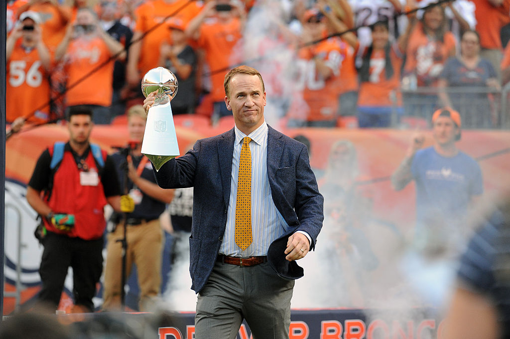 Former Denver Broncos quarterback Peyton Manning with a Super Bowl trophy