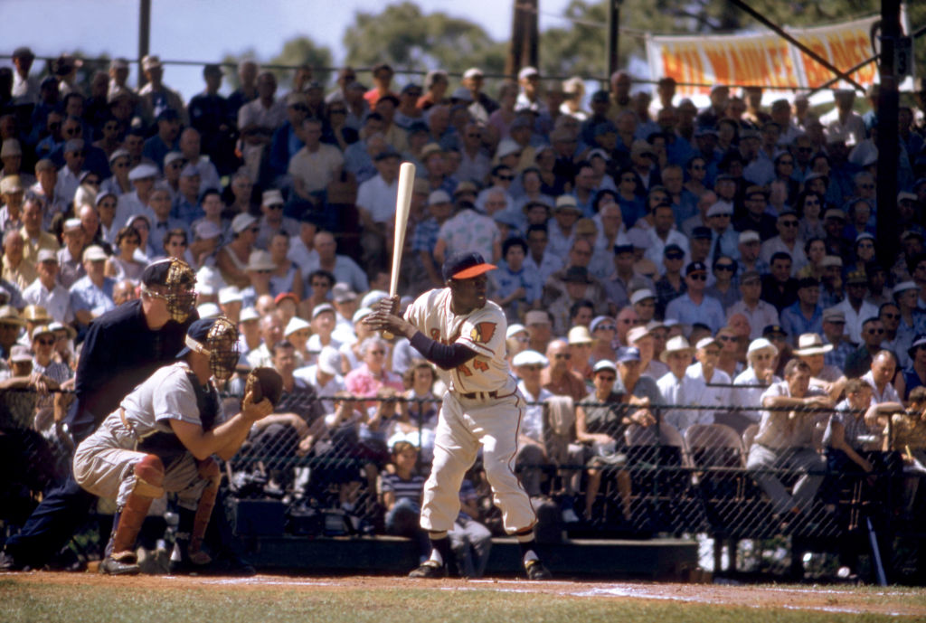 Hank Aaron of the Milwaukee Braves bats during an MLB Spring Training game in 1957