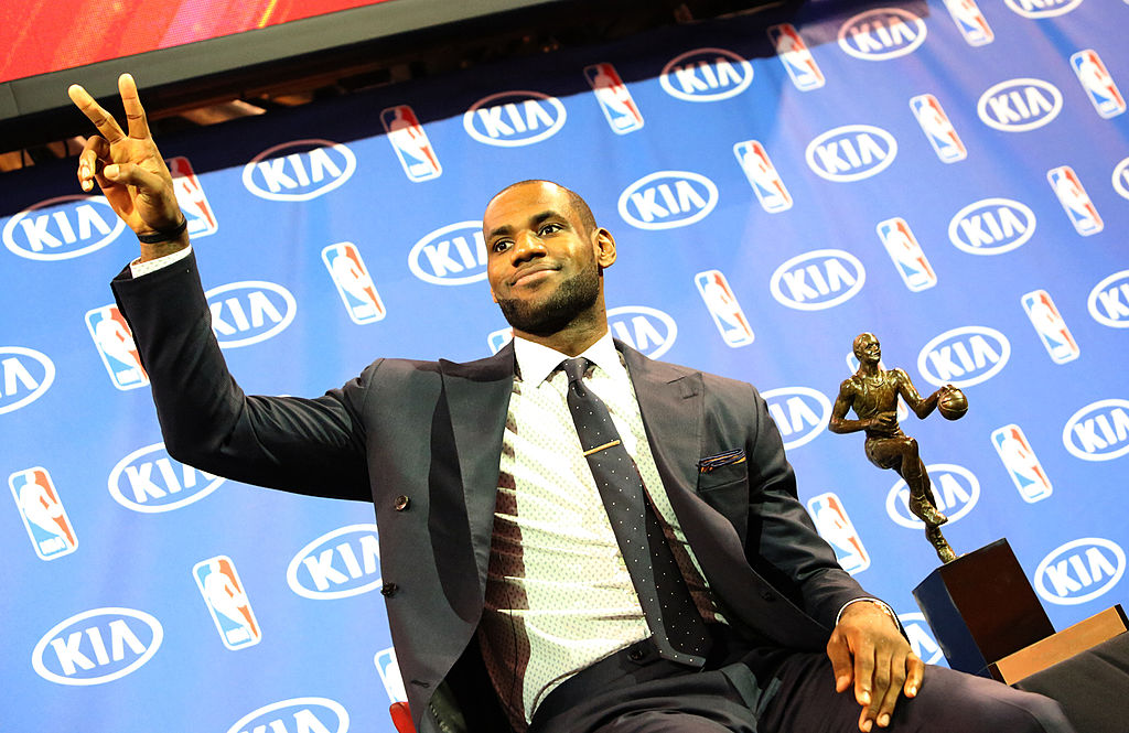 Miami Heat guard LeBron James sits by the Maurice Podoloff MVP Trophy