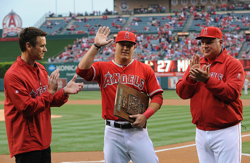 Mike Trout (C) of the Los Angeles Angels of Anaheim is presented with the Jackie Robinson Rookie of the Year Award in 2013