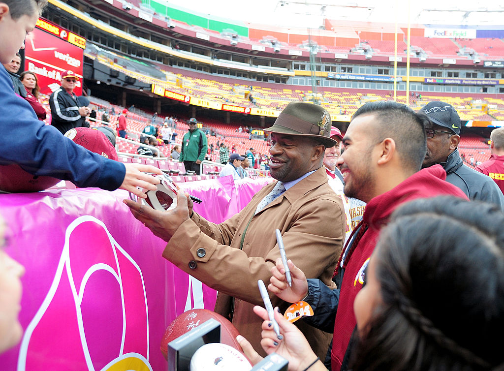NFLPA Executive Director DeMaurice Smith signs autographs prior to an NFL game