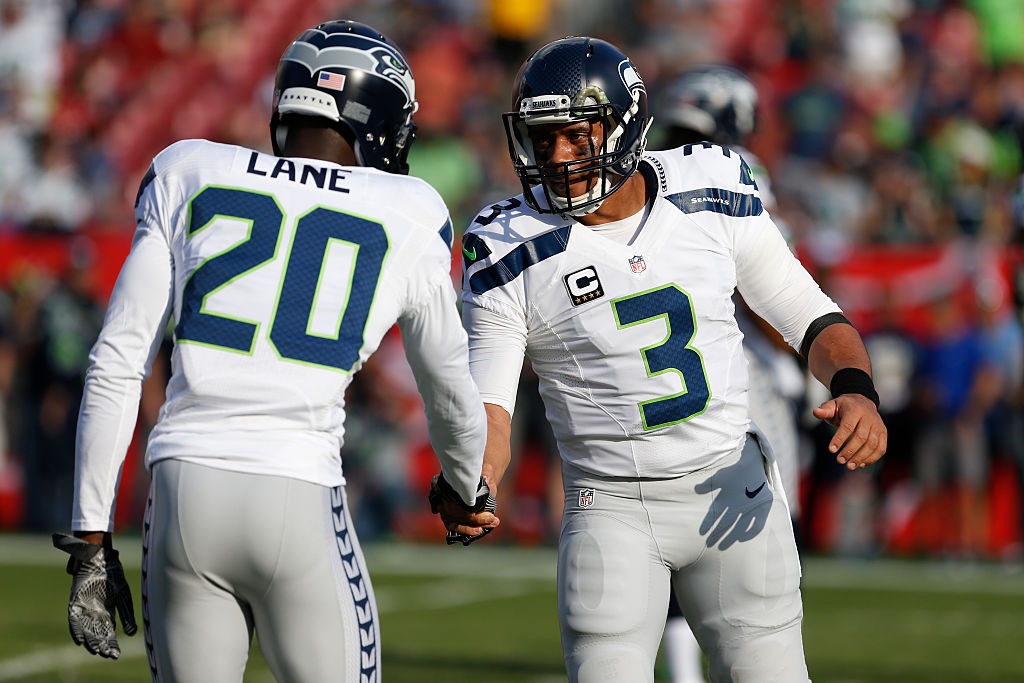 The Seahawks' quarterback Russell Wilson shakes hands with cornerback Jeremy Lane