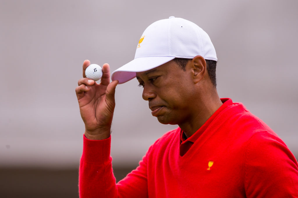 Tiger Woods collects his ball after a successful putt in 2019