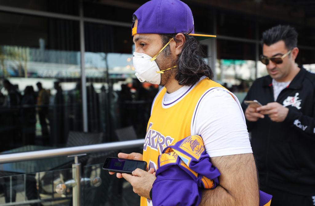 Fan wears mask as coronavirus affects sports