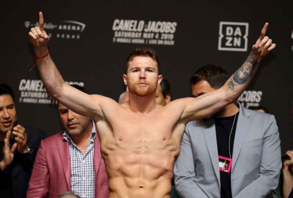 Canelo Alvarez poses on the scale during his official weigh in against Daniel Jacobs in 2019