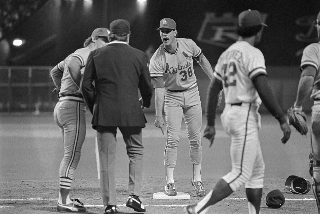 First base umpire Don Denkinger comes under attack in the ninth inning with Cardinals pitcher Todd Worrell complaining that Jorge Orta was out at first