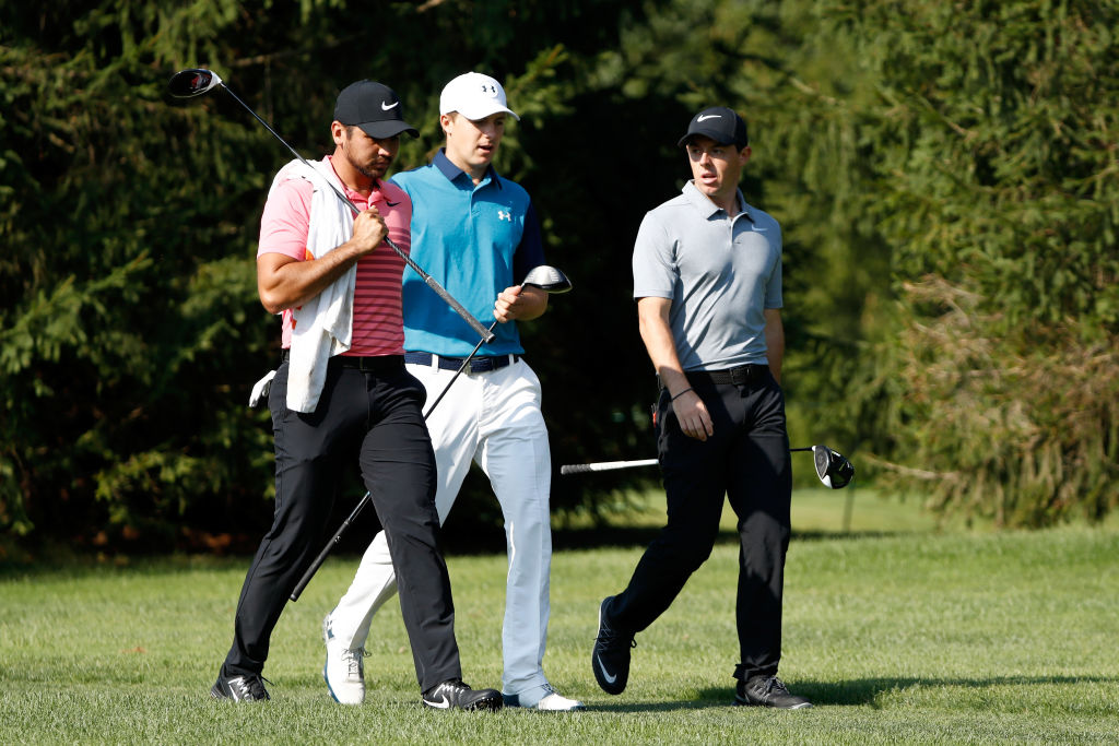 Jason Day, Jordan Spieth, and Rory McIlroy walk down the 16th fairway during the first round of the 2017 World Golf Championships