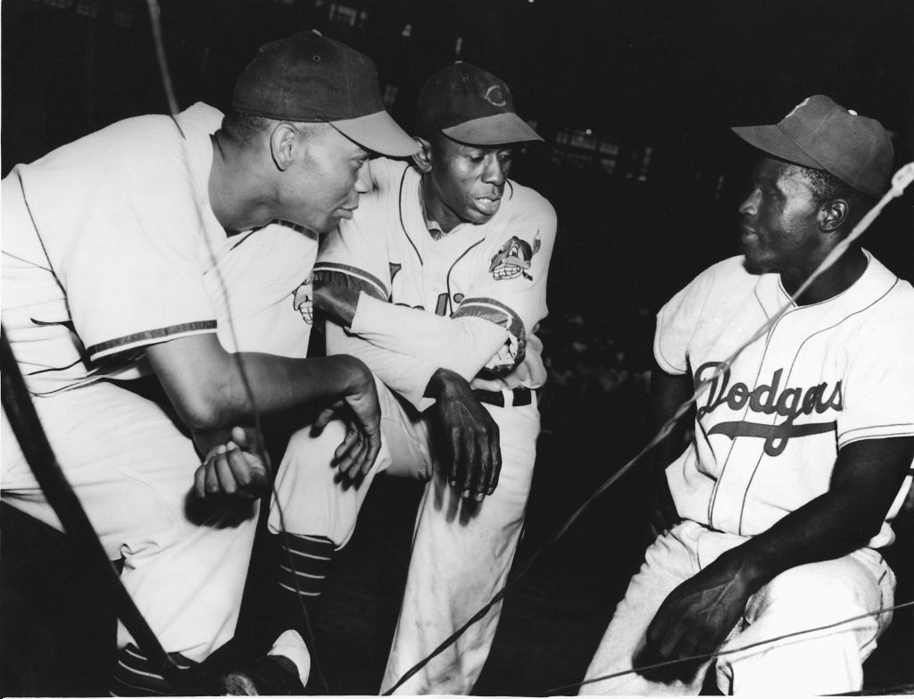Many black baseball players thought pitcher Satchel Paige (middle) would break baseball's color barrier. They weren't pleased when Jackie Robinson, right, achieved that honor in 1947.