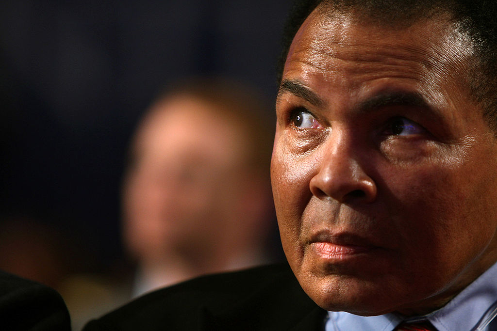 Muhammad Ali looking on at a global summit meeting