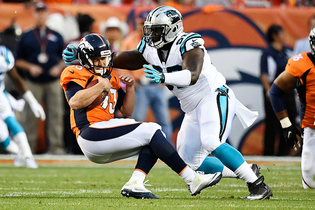 Quarterback Trevor Siemian of the Denver Broncos is tackled by defensive tackle Vernon Butler of the Carolina Panthers in 2016