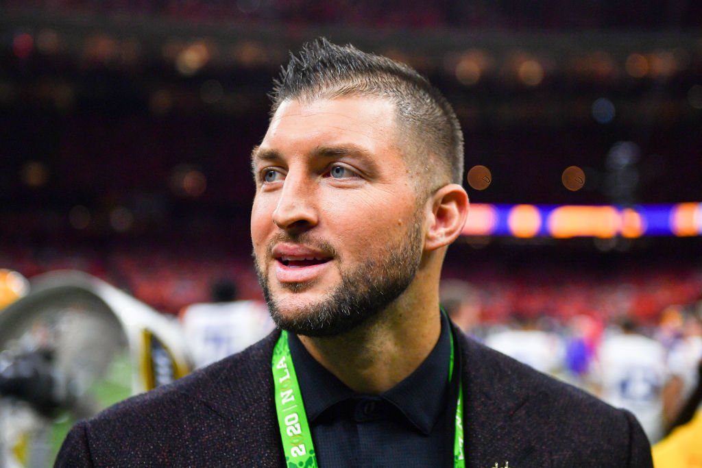 Retired NFL player Tim Tebow walks the sidelines of the 2020 College Football Playoff National Championship