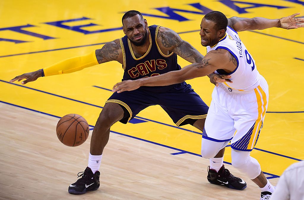 Andre Iguodala of the Golden State Warriors vies for the ball with LeBron James of the Cleveland Cavaliers