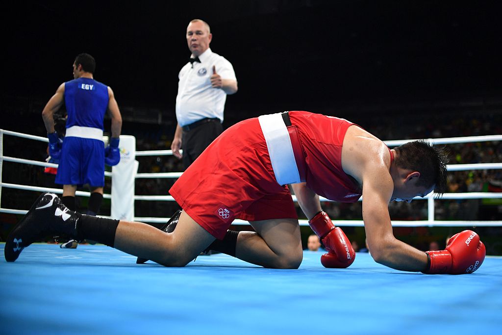 A boxer on his knees after being knockout during a match