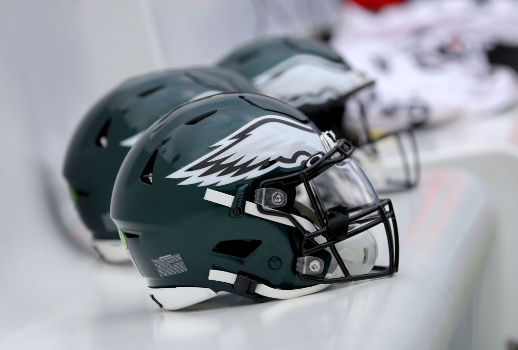 Philadelphia Eagles helmets lined up on the bench before a football game